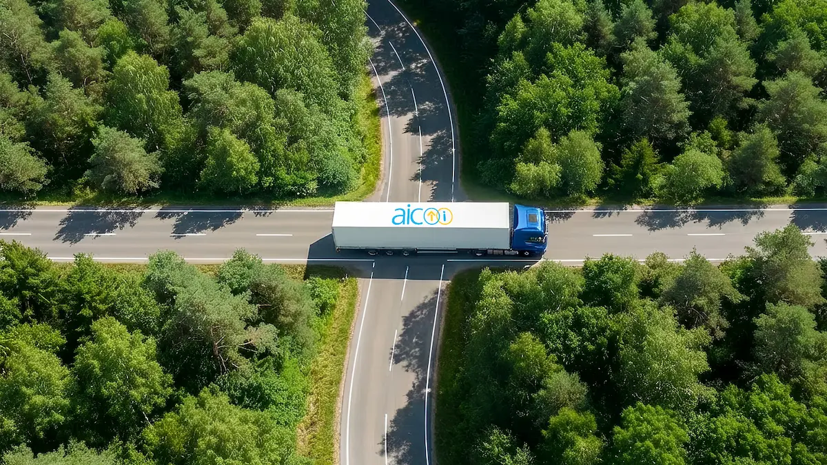 Aerial view of a delivery truck on a road through a forest
