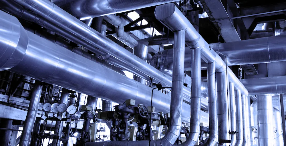 Industrial piping network in blue light